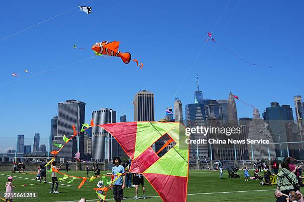 People fly kites during the annual Kite Festival at Brooklyn Bridge Park on May 17, 2025 in New York City.