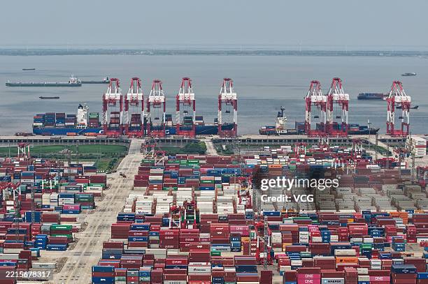 Aerial view of shipping containers sitting stacked at Shanghai Port on May 18, 2025 in Shanghai, China.