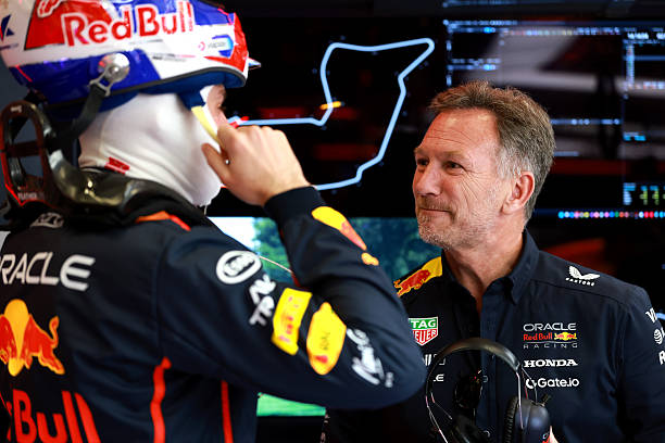 Max Verstappen of the Netherlands and Oracle Red Bull Racing and Christian Horner, Team Principal of Oracle Red Bull Racing talk in the garage prior...