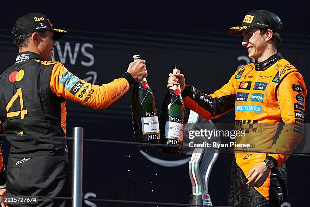 Second placed Lando Norris of Great Britain and McLaren and Third placed Oscar Piastri of Australia and McLaren celebrate with Champagne on the...