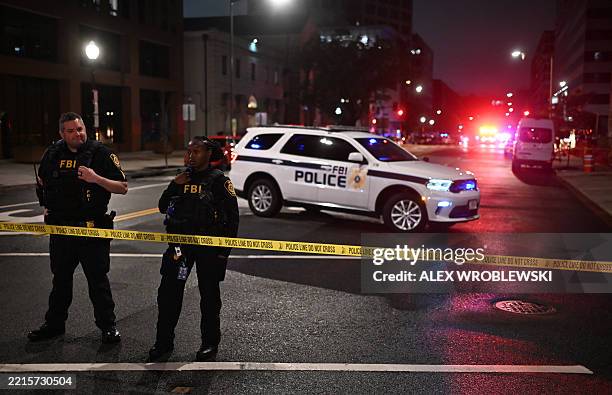 Agents cordon off the scene outside the Capital Jewish Museum following a shooting that left two people dead, in Washington, DC, in the early hours...