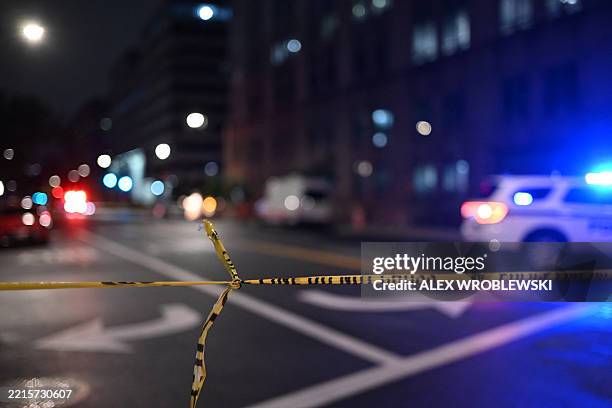 Police tape cordons off the street outside the Capital Jewish Museum following a shooting that left two people dead, in Washington, DC, in the early...