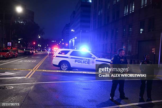 Agents cordon off the scene outside the Capital Jewish Museum following a shooting that left two people dead, in Washington, DC, in the early hours...