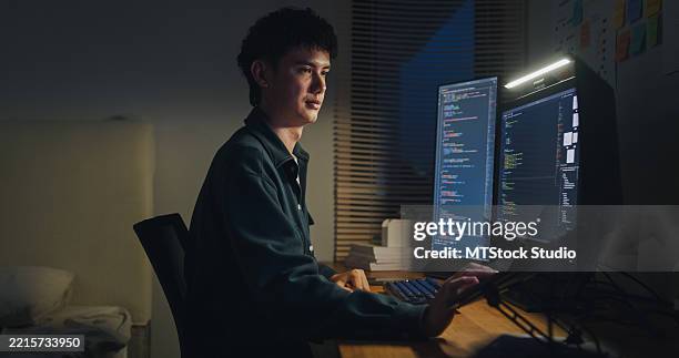 young man software engineer working late on ai prompts and web designs coding user experience on computer in bedroom at home night. software developer, artificial intelligence and programmer. - developer screen stock pictures, royalty-free photos & images