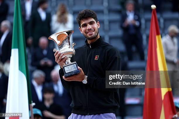 Carlos Alcaraz of Spain poses with the trophy as he celebrates victory against Jannik Sinner of Italy following the Men's Singles Final match on Day...