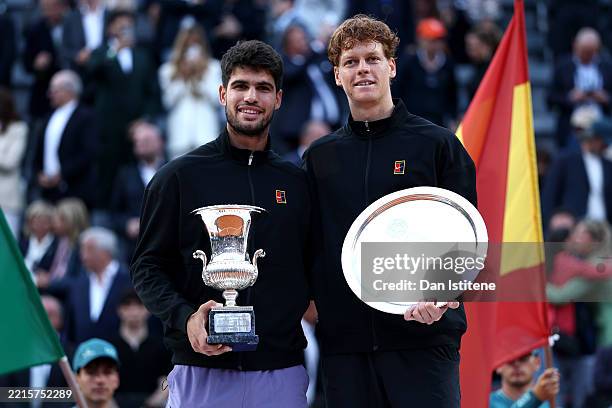 Carlos Alcaraz of Spain poses with the trophy as he celebrates victory alongside runner up Jannik Sinner of Italy following the Men's Singles Final...