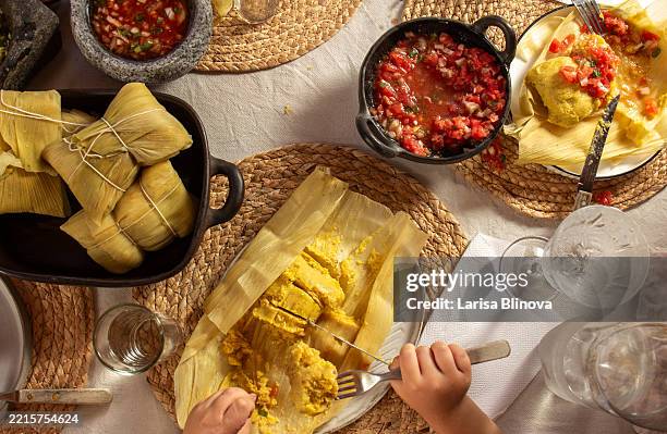A Table Of Traditional Latin American Corn Tamales Also Known As a-table-of-traditional-latin-american-corn-tamales-also-known-as