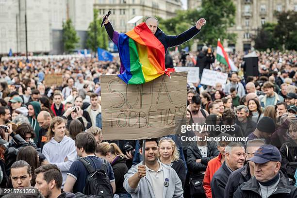 Demonstrator holds a banner that shows Russian President Vladimir Putin during a protest against the 'Transparency Bill' on May 18, 2025 in Budapest,...