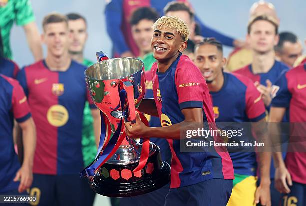 Lamine Yamal of FC Barcelona lifts the La Liga EA Sports title trophy following the La Liga EA Sports match between FC Barcelona and Villarreal CF at...