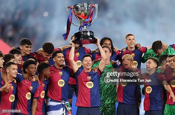Robert Lewandowski of FC Barcelona lifts the La Liga EA Sports title trophy following the La Liga EA Sports match between FC Barcelona and Villarreal...