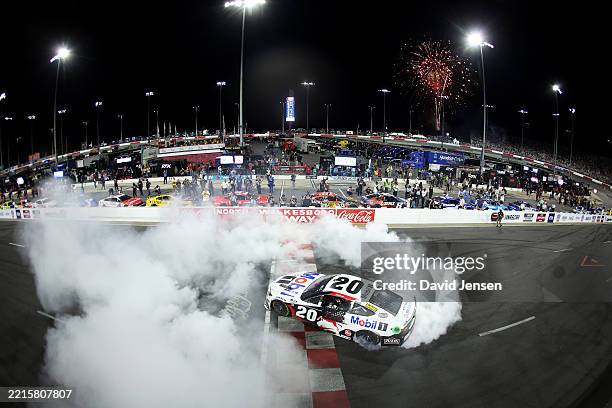 Christopher Bell, driver of the Mobil 1 Toyota, celebrates with a burnout after winning the NASCAR Cup Series All-Star Race at North Wilkesboro...