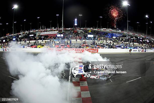 Christopher Bell, driver of the Mobil 1 Toyota, celebrates with a burnout after winning the NASCAR Cup Series All-Star Race at North Wilkesboro...