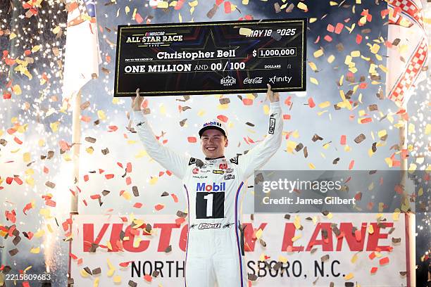 Christopher Bell, driver of the Mobil 1 Toyota, poses with the one million dollar check in victory lane after winning the NASCAR Cup Series All-Star...