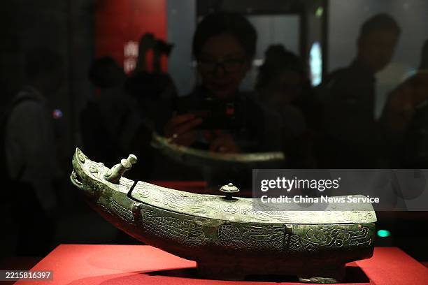 Visitors view an exhibit at the exhibition "The Exhibition Series on the Origins of Chinese Civilization: This is the Shang" at the Grand Canal...
