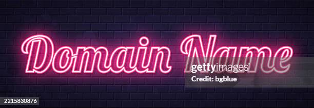 domain name - glowing neon text on brick wall background - domain stock illustrations