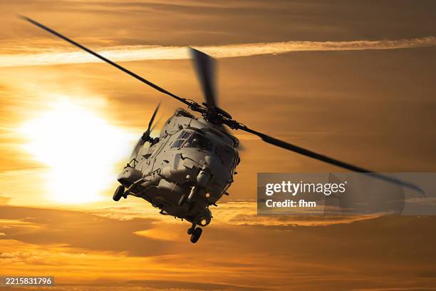 military helicopter in the sunset sky - military airplane stock pictures, royalty-free photos & images