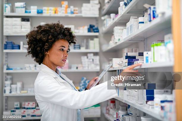 pharmacist organizing medicine on shelves in professional pharmacy setting - your talent rx stock pictures, royalty-free photos & images