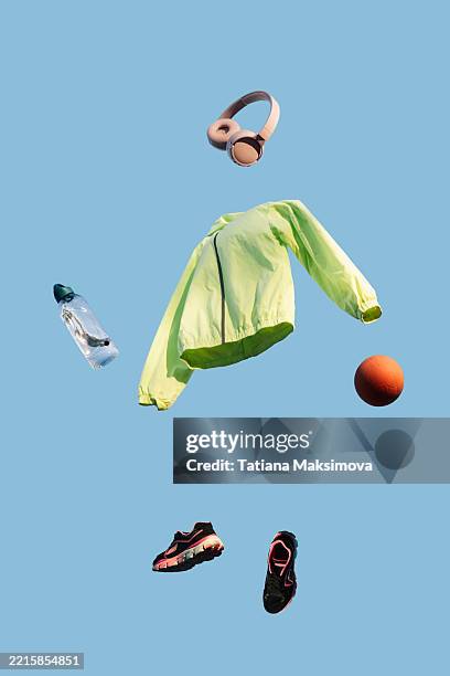 flying sports equipment on the blue sky background. zero gravity concept of sport. - zero gravity stock pictures, royalty-free photos & images
