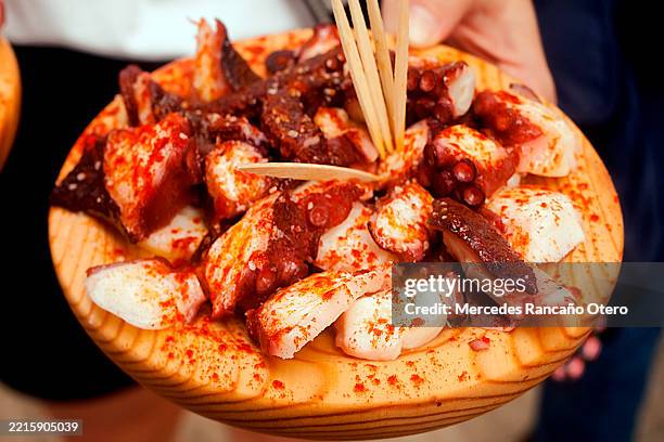 octopus "a feira" style. tradition. galicia, spain. - galicia stock pictures, royalty-free photos & images