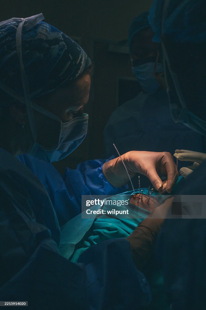 Surgeon Performing Eye Brachytherapy Procedure on Patient in Surgery Room