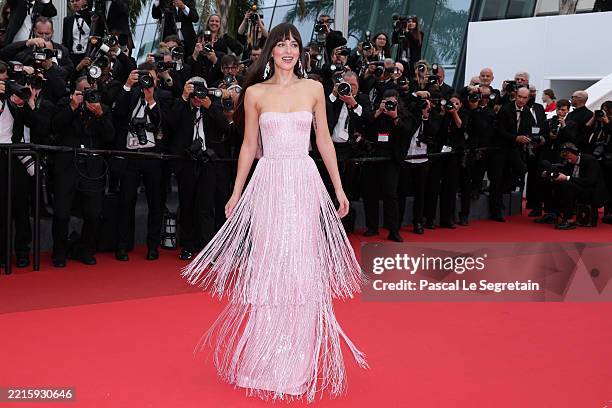 Dakota Johnson attends the "Highest 2 Lowest" red carpet at the 78th annual Cannes Film Festival at Palais des Festivals on May 19, 2025 in Cannes,...
