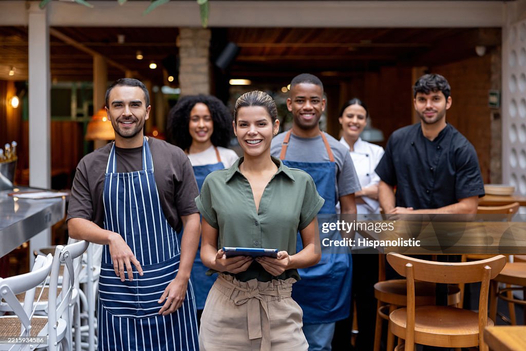 Happy business manager smiling with a group of employees at a restaurant