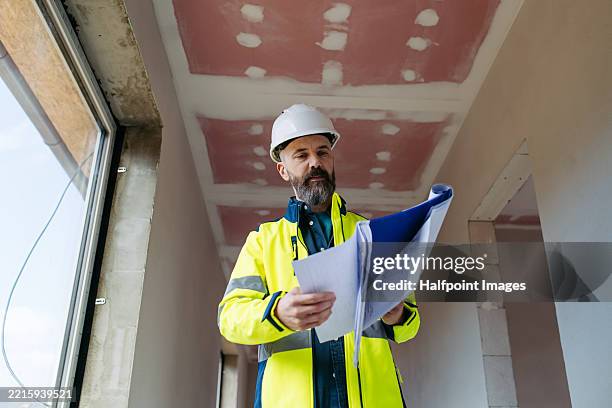construction manager inspecting site progress, construction work. - measuring window stock pictures, royalty-free photos & images
