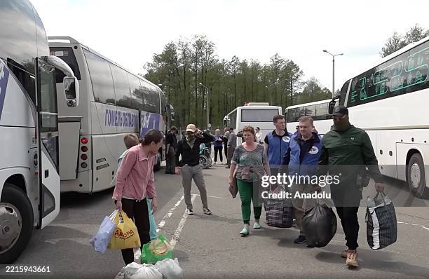 Screen capture from a video shows Russian civilians being returned to Russia after the Russian Defense Ministry announced on Friday that Moscow and...