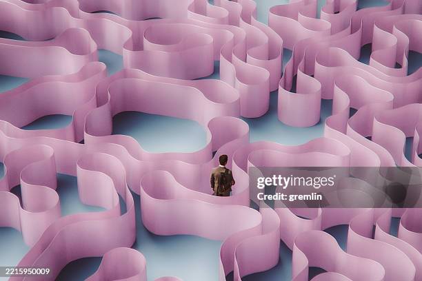 businessman entangled in abstract futuristic maze - stuck stock pictures, royalty-free photos & images