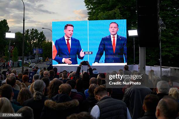 Warsaw's Mayor and presidential candidate Rafal Trzaskowski and historian, Karol Nawrocki are seen on a screen during a presidential debate on...