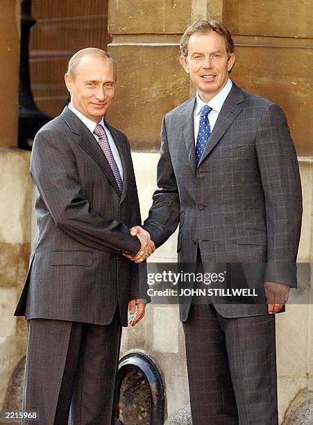 Russia s President Putin shakes hand with British Prime Minister Tony Blair as they arrive at Lancaster House in London Thursday 26 June, 2003 for a...