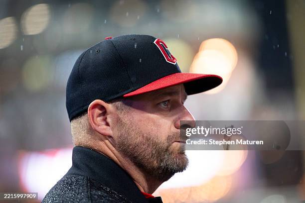 Manager Stephen Vogt of the Cleveland Guardians looks on during a rain delay in the top half of the fourth inning of the game against the Minnesota...