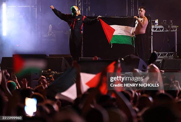 Naoise O Caireallain and JJ O'Dochartaigh of Northern Irish Hip Hop trio Kneecap, hold up an Palestine flag after performing onstage during Wide...