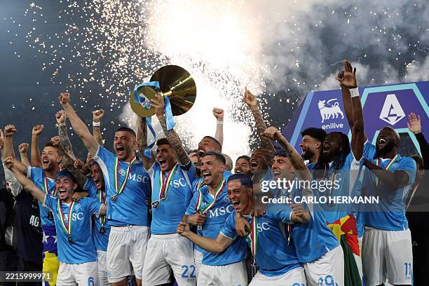 Napoli's Italian defender Giovanni Di Lorenzo lifts the trophy with teammates during a ceremony for the Italian Champions following the Italian Serie...