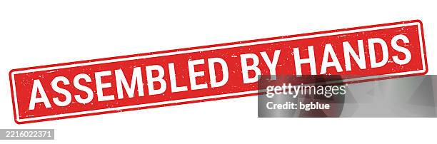 assembled by hands - red rubber stamp on white background - hands making letters stock illustrations