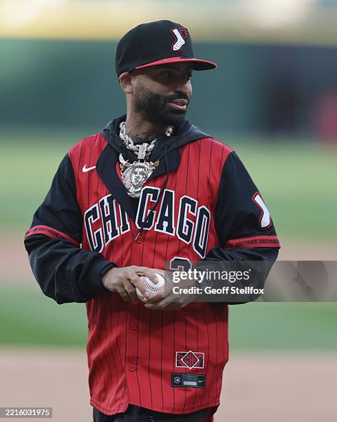 Reggaeton artist Arcángel throws the first pitch at Rate Field on May 23, 2025 in Chicago, Illinois.