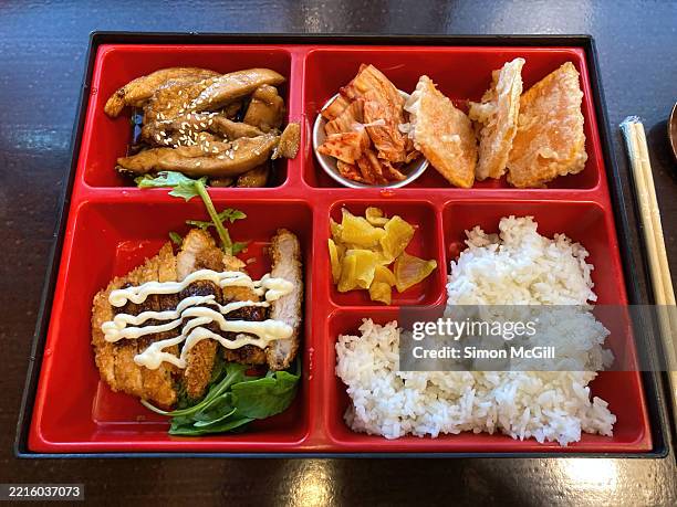 bento box with teriyaki chicken, kimchi, tempura pumpkin, pork tonkatsu, pickled radish and rice - tempura stock pictures, royalty-free photos & images