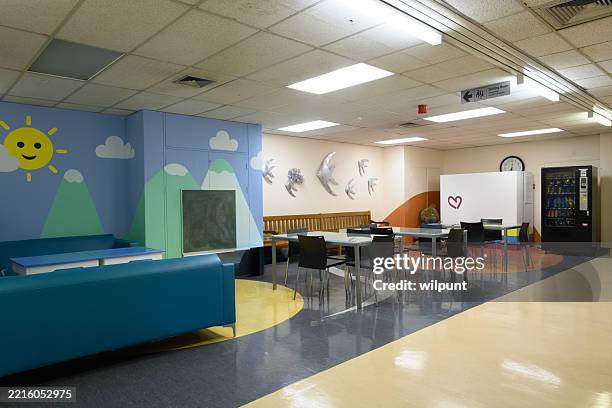 bright hospital waiting room with colorful decorations and seating area - community center interior stock pictures, royalty-free photos & images