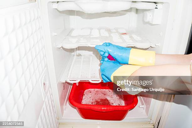 removing ice from a domestic freezer - frys bildbanksfoton och bilder
