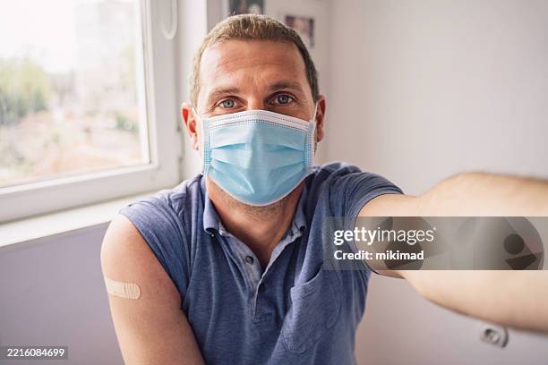 confident man after vaccine with casual outfit - vaxxie stock pictures, royalty-free photos & images