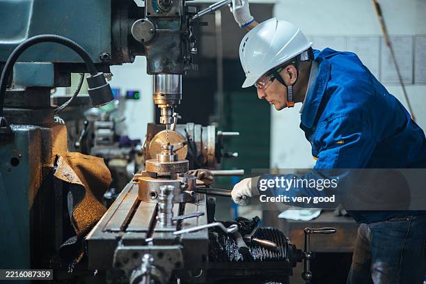 asian male engineer working on lathe - metal worker stock pictures, royalty-free photos & images