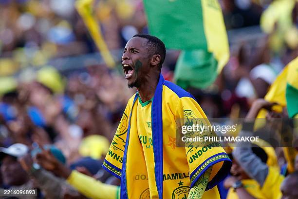 Sundowns supporter celebrates his team's goal during the first leg of the CAF Champions League final football match between Mamelodi Sundowns and...