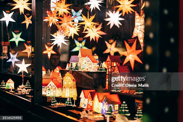 festive christmas market display with illuminated stars and miniature houses - julmarknad bildbanksfoton och bilder