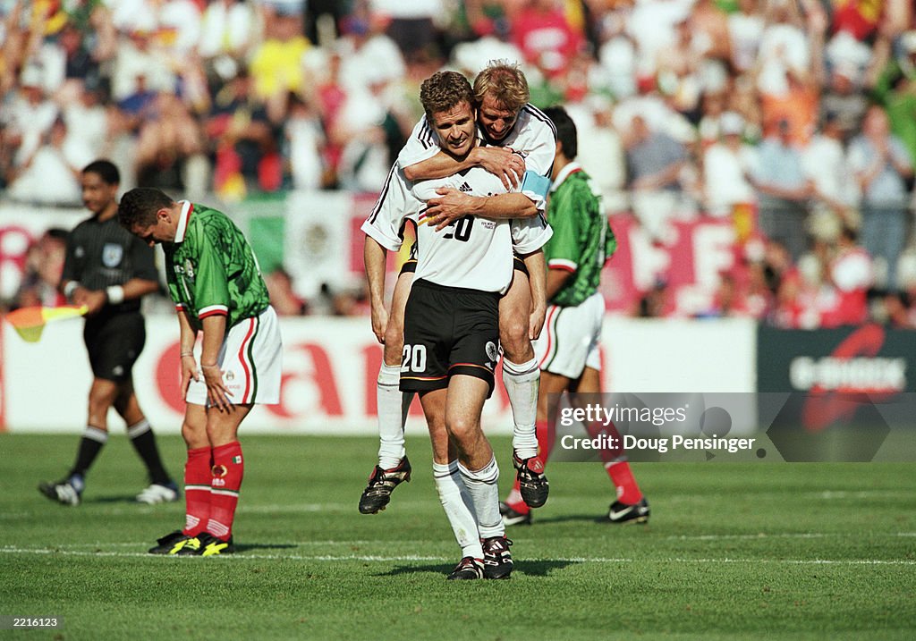 Oliver Bierhoff of Germany is congratulated by team-mate Jurgen Klinsmann after scoring the winning goal