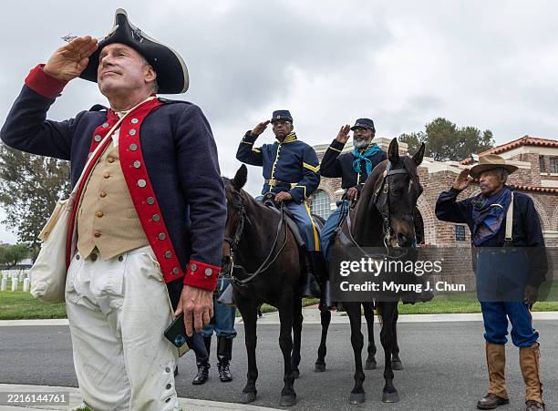 Jim Olds, left, of the Sons of the Revolution; Larry Thornton, Todd LaVergne and August Simien Jr. Of the New Buffalo Soldiers, salute during the...