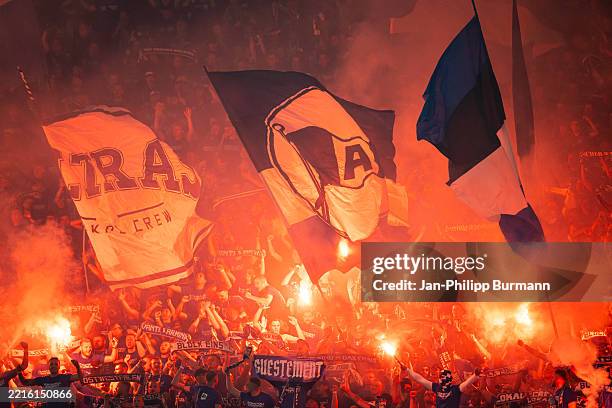 Fans of Arminia Bielefeld ignite pyrotechnics during the DFB Cup Final match between DSC Arminia Bielefeld and VfB Stuttgart on May 24, 2025 at...