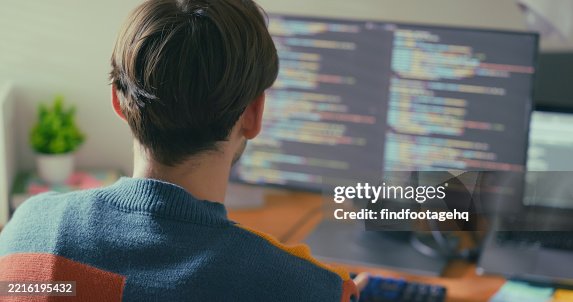 A dedicated programmer working on multiple computer screens, immersed in writing code. A dedicated programmer working on multiple computer screens, immersed in writing code.