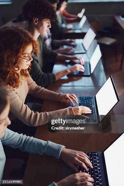 above view of students e-learning over computers in the classroom. - technology college stock pictures, royalty-free photos & images