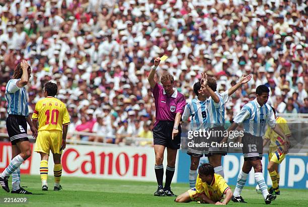 Oscar Ruggeri of Argentina is shown a yellow card during the FIFA World Cup Finals 1994 Second Round match between Romania and Argentina held on July...