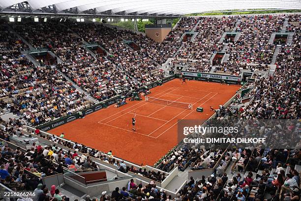 This photograph shows a general view of Court Suzanne-Lenglen as Belgium's Zizou Bergs serves to France's Giovanni Mpetshi Perricard during their...